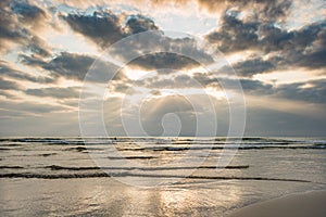 Cloudy sky on tranquil beach at sunset evening