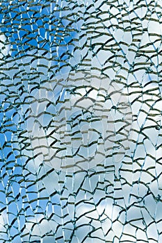 Cloudy sky view through broken glass