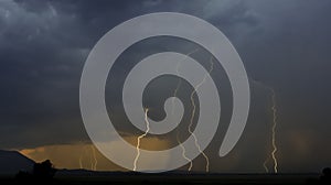 Cloudy sky with visible lightnings while raining at mountain lan