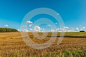 A cloudy summer sky above the field after haymaking