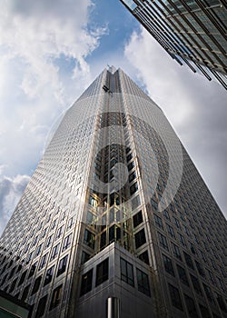 Cloudy and sunny sky with a modern building at One Canada Sqare photo