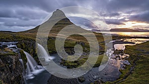 Cloudy sunrise at the iconic Kirkjufellsf waterfall in the The Snaefellsnes Peninsula, West Iceland