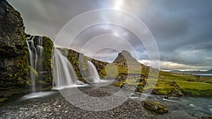 Cloudy sunrise at the iconic Kirkjufellsfoss waterfall in the The Snaefellsnes Peninsula, West Iceland