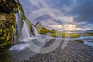 Cloudy sunrise at the iconic Kirkjufellsfoss waterfall in the The Snaefellsnes Peninsula, West Iceland