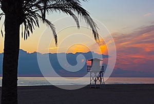 Cloudy sunrise over Mediterranean Sea beach in Valencia region of Spain.