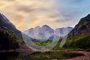 Cloudy sunrise view of majestic Maroon Bells mountain range