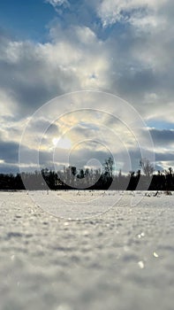 Cloudy sunset over the snowy field