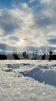 Cloudy sunset over the snowy field