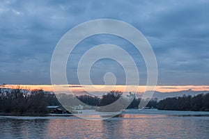 Cloudy sunset over usce, the confluence between the sava and the danube dunav river and the panorama of New Belgrade