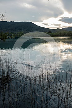 Cloudy sunset on quiet water lake in Banyoles, Catalonia