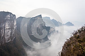 Cloudy Tian Men Mountains in Zhangjiajie with red praying fabric .