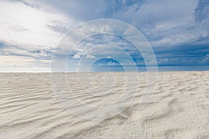 Cloudy tropical landscape. Beach view with sand and sea under overcast sky