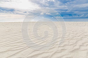 Cloudy tropical landscape. Beach view with sand and sea under overcast sky