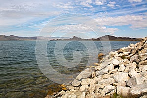 Cloudy view on a mountain lake. Mongolia rockery shore