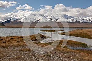 Cloudy view on a mountain lake. Mongolia snow hills