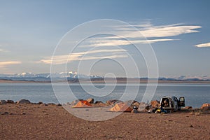 Cloudy view on a mountain lake. Mongolia tent on beach