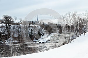 Cloudy winter landscape featuring the river crossing town with the St. Ludger catholic church in the background