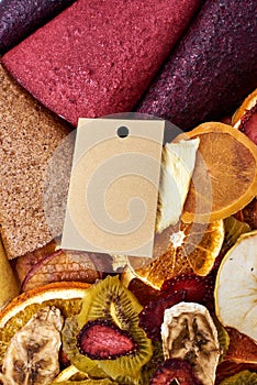 Clouse-up dried fruits and fruit pastille with craft paper card