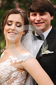 Clouse-up portrait of happy wedding couple. Broom and bride