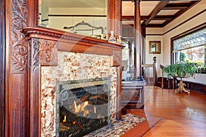 Clouse up view of antique fireplace with decorative tile trim.