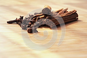 Clove spice cinnamon sticks on a wooden board