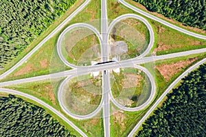 Clover or daisy, a simple and cheap type of road junction. Aerial view of highway road junction in the in the Kostroma region,