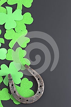 Clover and horseshoe on a dark background. St. Patrick`s Day.