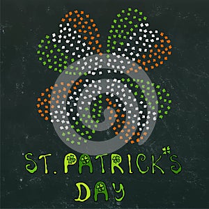 Clover Leaves Heart Shaped Colored in Ireland Flag Colours Green, White, Orange. On a Black Board Background. With St Patricks Day