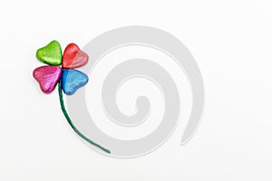 Clover-shaped flower with colorful hearts petals.