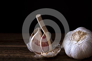 Cloves of garlic and garlic on a wooden table