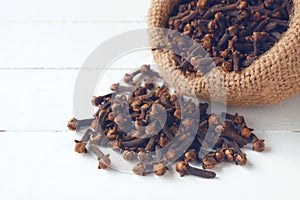 Cloves on white wooden table.