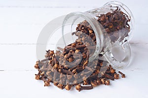 Cloves on white wooden table.