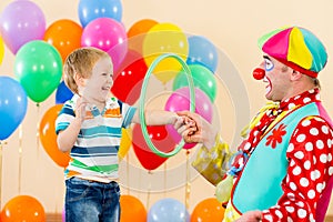 Clown amusing child boy on birthday party