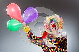 The clown with balloons in funny concept