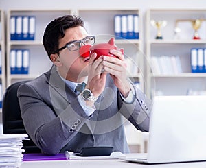 Clown businessman with piggy bank doing accounting