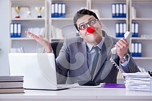 The clown businessman working in the office