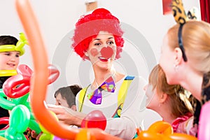 Clown at children birthday party with kids