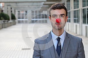 Clown dressed in a formal suit with copy space