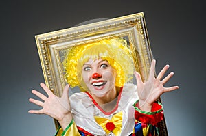 The clown in funny concept on dark background