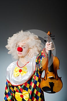 The clown in funny concept on dark background