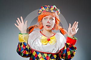 The clown in funny concept on dark background