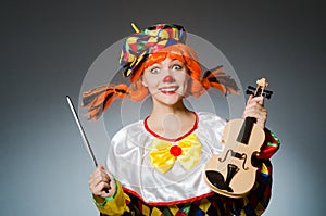 The clown in funny concept on dark background