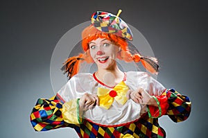 The clown in funny concept on dark background