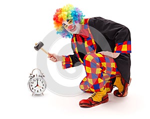 Clown hitting alarm clock with hammer