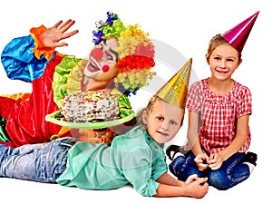 Clown holding cake on birthday with group children