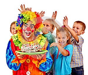 Clown holding cake on birthday with group children