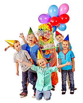 Clown holding cake on birthday with group children