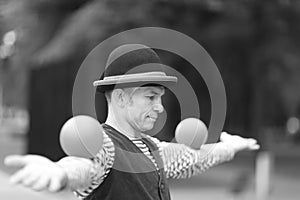 The clown juggles balls on the street photo