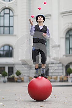 The clown juggles with pink balls photo