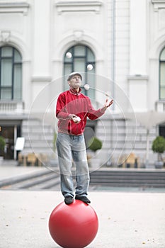 The clown juggles with white balls photo